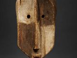 a wooden mask with a face made out of wood