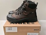 a close up of a pair of brown hiking boots on top of a box