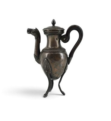 an old metal teapot with a bird handle on a white background