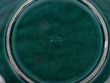 a close up of a green plate with a name on it