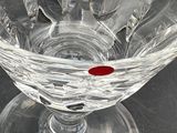 a red dot in the middle of a glass bowl