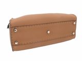 a close up of a tan purse on a white background