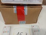a box of remotes sitting on a table next to a box of remotes
