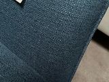 a label on the back of a blue couch
