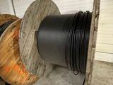 a spool of black wire on a reel in a room