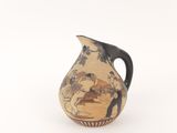 a small vase with a painting on it on a white surface