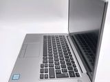 a silver laptop computer sitting on top of a white table