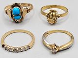 a group of five gold rings and a turquoise stone ring