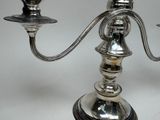 a silver candelab with two candles on top of it