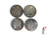 four silver coins with the image of jesus and other figures on them