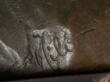 a close up of a statue of a horse with a name on it