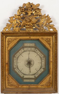 une horloge dorée accrochée au mur, avec un cadre bleu