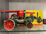 a toy steam engine on display on a glass shelf