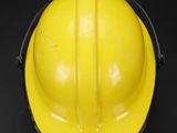 a yellow hard hat on a black background