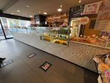 a store with a counter with a variety of food on it