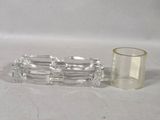 a glass candle holder and a glass candle holder on a table