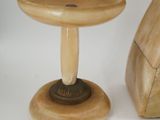 a small wooden object sitting next to a small wooden object