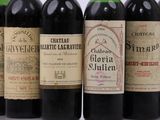 several bottles of wine are lined up on a table