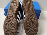 adidas shoes in a box and a pair of shoes on a table