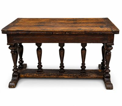 an old wooden table with turned legs and a wooden top