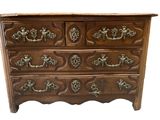an image of a wooden chest of drawers with ornate handles