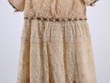 an image of a dress hanging on a hanger on a wall