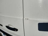 a close up of a white van with a black door handle