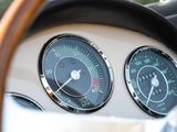 two gauges on the dashboard of a classic car