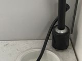 a sink with a black faucet and a black faucet on it