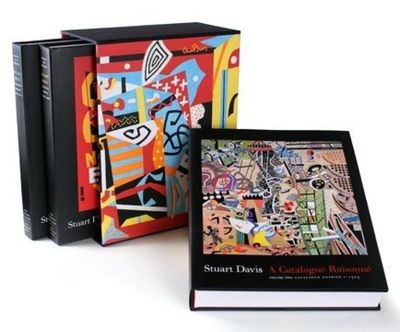 two books are sitting on a white surface next to each other