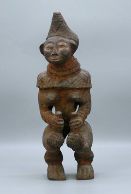 a close up of a statue of a person with a hat on