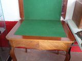 a small table with a green cushion on it