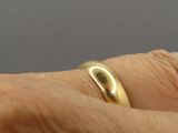 a close up of a person ' s hand with a ring on it
