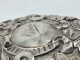a close up of a silver plate with a clock on it