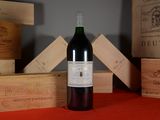 a bottle of wine sitting on a table next to wooden boxes