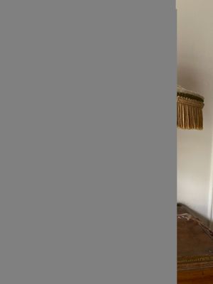 a bed and a lamp in a room with white walls