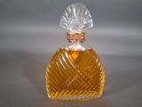 a small glass bottle with a clear top on a table