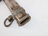 a small metal object that is on a white surface
