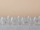 a lot of glasses sitting on a table next to each other