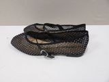 pair of black and silver shoes with a buckle on the heel