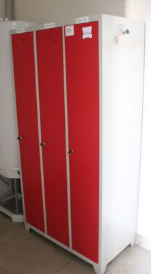 a red and white locker in the corner of a room