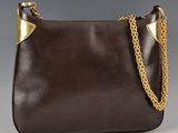 a brown purse with a gold chain hanging from it