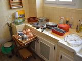 a small kitchen with a lot of clutter on the counter
