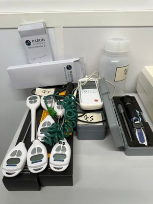 several electronic devices are sitting on a desk in a room