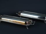 two silverplated trays with handles and handles on a black background