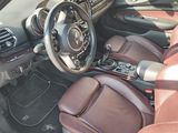 the interior of a car with red leather seats and a steering wheel