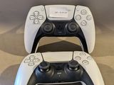two video game controllers sitting next to each other on the floor
