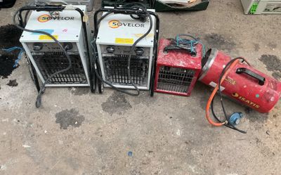 two air compressors and a blower sitting on the ground
