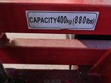 a picture of a red bench with a sign on it