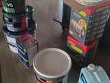many cans of paint on a table in a store